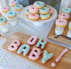 a table topped with lots of donuts and cupcakes