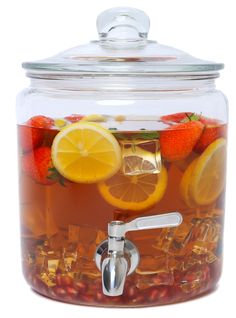 a glass jar filled with tea and lemons