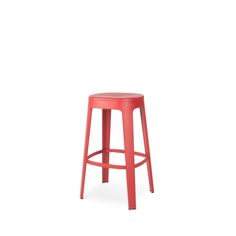 a red stool sitting on top of a white floor