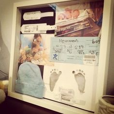 a baby's hand and foot prints in a shadow box