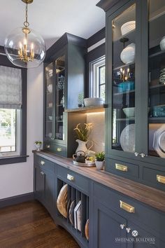 a kitchen with black cabinets and gold trim on the doors is pictured in this image