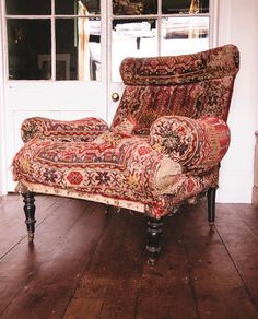 an old chair sitting in front of a white door