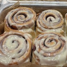 several cinnamon rolls sitting in a baking pan