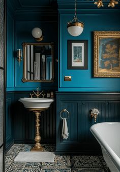 a bathroom with blue walls and gold fixtures