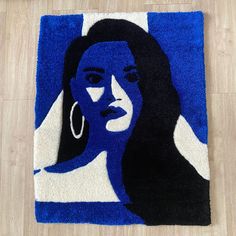 a blue and black rug with a woman's face on it