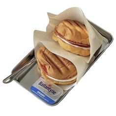 two sandwiches sitting on top of a metal tray