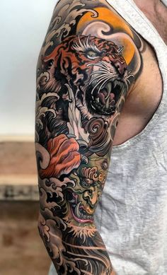 a man with a tiger tattoo on his arm