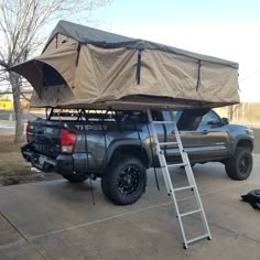 a truck with a tent attached to the roof