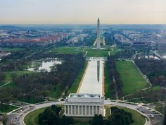 an aerial view of the washington monument in washington d c, with trees and buildings surrounding it