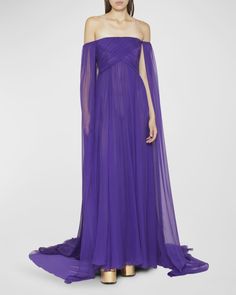 Valentino Garavani chiffon cape gown featuring crossover front detail Off-the-shoulder neckline Long sleeves A-line silhouette Floor sweeping hem Hidden closure Silk Made in Italy Gala Dresses Classy, Circle Skirt Outfits, Wedding Guest Dresses Long, Chiffon Cape, Valentino Gowns, Shoulder Cape, Cape Gown, Purple Gowns, Shoulder Ruffle Dress