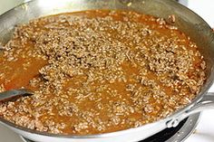 a pan filled with food sitting on top of a stove