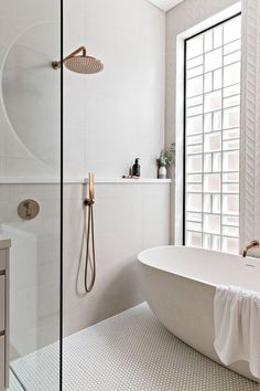 a white bath tub sitting next to a window