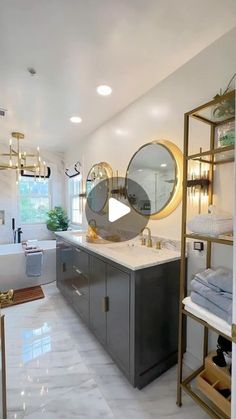 a bathroom with marble flooring and gold accents on the walls, along with a large mirror