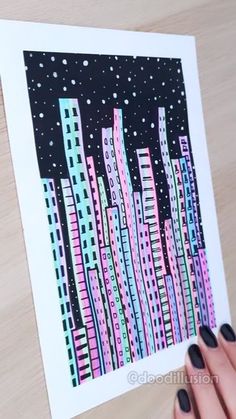 a person holding up a card with cityscape in the background and stars on it