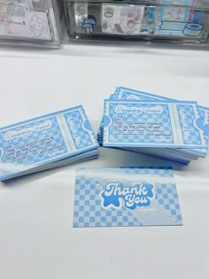 four blue tickets sitting on top of a table next to some plastic containers filled with candy