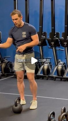 a man standing in front of a row of dumbbells