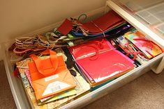 an open drawer filled with assorted items on the floor