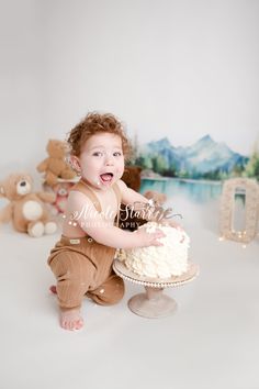 a baby is sitting in front of a cake