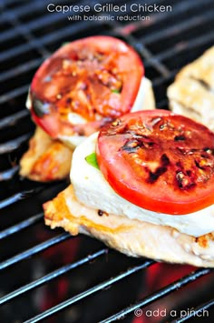 grilled chicken with tomatoes and mozzarella cheese on top, sitting on the grill