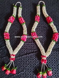 two pieces of beaded necklaces with flowers and beads hanging from the sides on a black surface