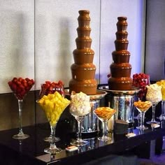 a table with chocolate fountains and desserts on it