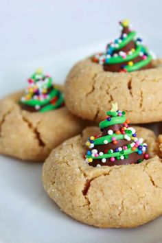 cookies decorated with christmas trees on a white plate