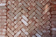 an old brick wall that has been made into a herringbone pattern