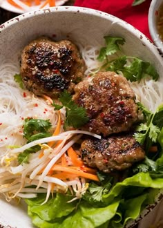 two meat patties and some vegetables in a bowl