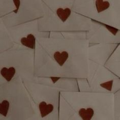 many envelopes with red hearts on them