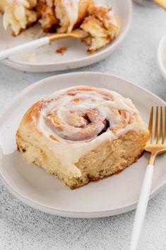 cinnamon roll on a plate with a fork