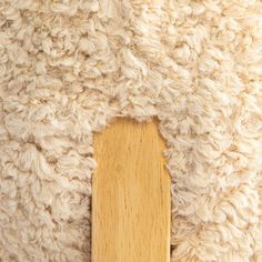 a close up of a sheep's wool and wooden frame