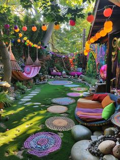 an outdoor area with lots of different colored decorations and rocks on the grass in front of it