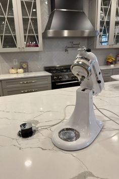 a white mixer sitting on top of a kitchen counter