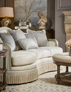 a living room filled with lots of furniture and flowers on top of a coffee table