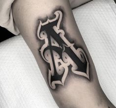 a black and white tattoo on the arm of a person with a cross in it