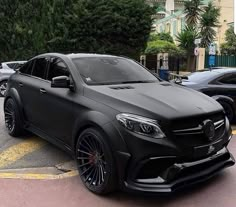 a black mercedes benz amg parked in a parking lot