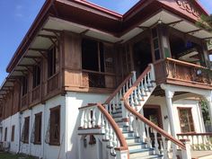 a large white house with wooden balconies