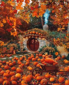 a painting of pumpkins in front of a hobbot with an entrance surrounded by trees