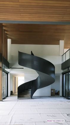 a large spiral staircase in an empty building