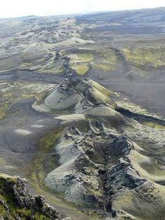 an aerial view of mountains and valleys in the desert