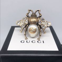 This 100% Authentic Gucci Bee Ring Is Made With An Aged Gold-Tone Finish, Enriched With Aged Crystals At The Wings. A Cream Pearl Makes Up The Body With Interlocking G Detail. -100% Authentic -Designer Size: Xs (Us 5 1/4), M (Us 7 1/2) -Made In Italy - Come With Gucci Ring Box Gold Trunk, Gucci Bee, Gucci Ring, Open Heart Ring, Bee Ring, Silver Heart Ring, Guccio Gucci, Vintage Bee, Gucci Jewelry