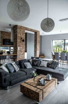 a living room filled with furniture and large windows