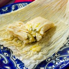 a plate with some food on it and someone's hand reaching for the wrap