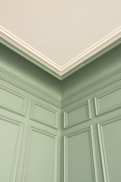 an empty room with green cabinets and a white ceiling