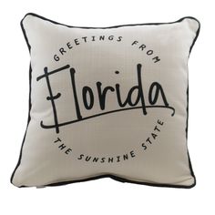 a white pillow with the words florida on it and black trimmings, in front of a white background