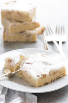 a white plate topped with cake next to a fork