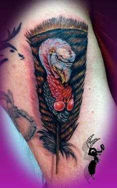 a tattoo on the back of a woman's shoulder with a turkey in it