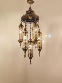 a chandelier hanging from the ceiling in a room with white walls and flooring