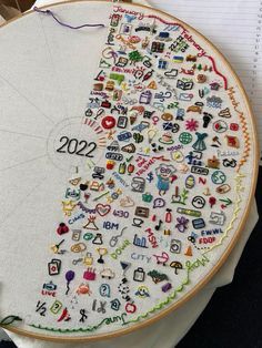 a cross - stitch project with the number 20 on it, and an embroidered piece of paper