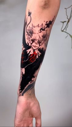 a person's arm with a black and red tattoo design on the left forearm